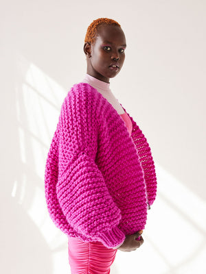 Girl wears chunky knitted pink-purple cardigan