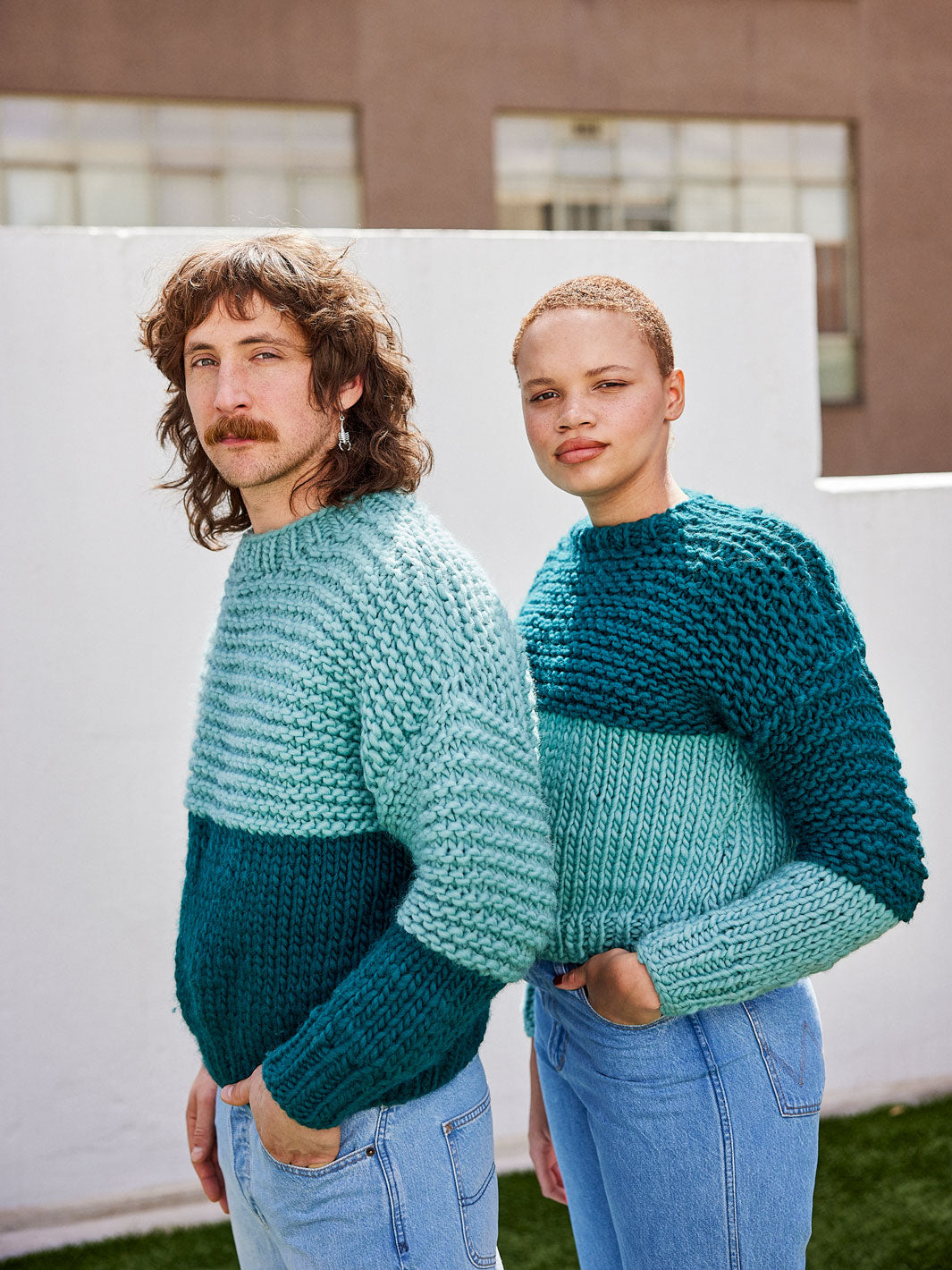Man and woman wear matching chunky knit jumpers