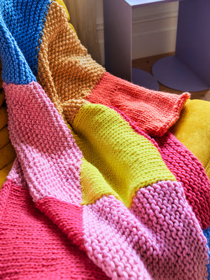 Detail photo of knitted merino Milo blanket, showing the luxe texture and vibrant colours.