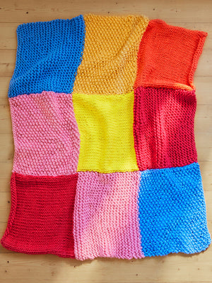 Detail photo of knitted merino Milo blanket, showing the luxe texture and vibrant colours.