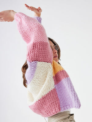 Model wears a pastel colour blocked chunky cardigan by cardigang