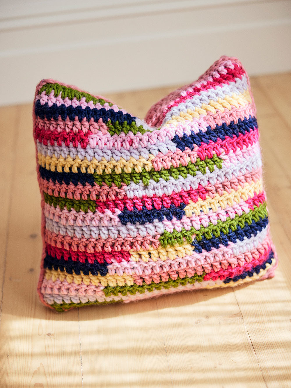 Image of a textured and colourful crocheted cushion