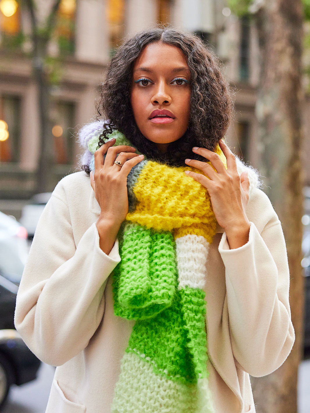 Woman wears chunky knitted mohair scarf wrapped around her neck